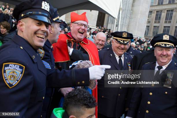 New York City Cardinal Timothy Dolan greets marchers in front of St. Patrick's Cathedral during the annual St. Patrick's Day Parade, where marching...