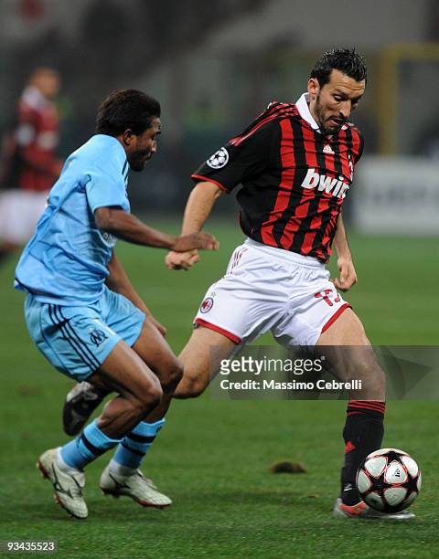 Gianluca Zambrotta of AC Milan battles for the ball against Bakari Kone of Olympique de Marseille during the UEFA Champions League Group C match...