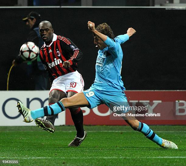 Clarence Seedorf of AC Milan battles for the ball against Gabriel Heinze of Olympique de Marseille during the UEFA Champions League Group C match...