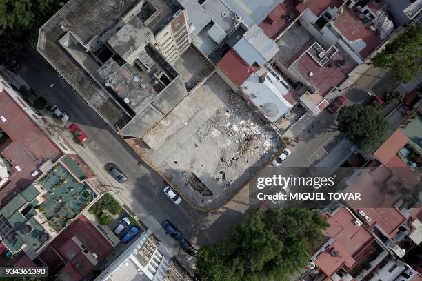 This aerial picture taken on March 17 shows the empty space left after a building damaged during the September 19, 2017 earthquake at Escocia street...