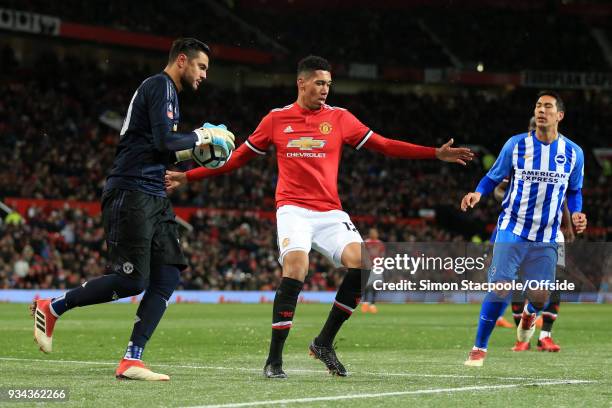 Chris Smalling of Man Utd shields the ball back to Man Utd goalkeeper Sergio Romero as Leonardo Ulloa of Brighton closes in during The Emirates FA...