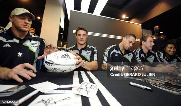 New Zealand All Blacks' playersBrad Thorn , Dan Carter , Luke McAlister, Jimmy Cowan and Ma'a Nonu sign autographs during an autograph session in a...