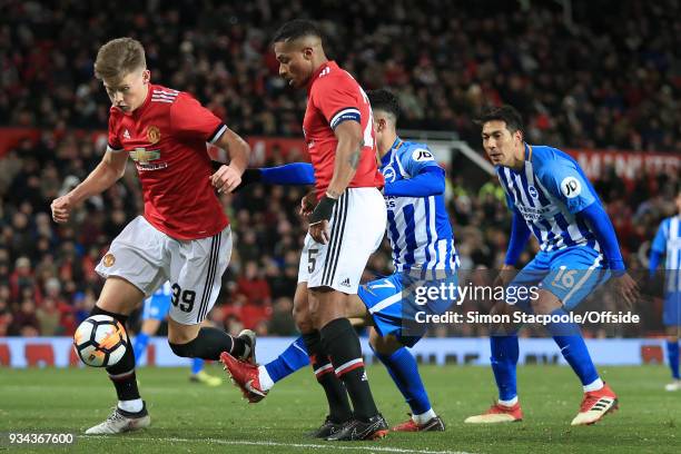 Scott McTominay of Man Utd helps teammate Luis Antonio Valencia of Man Utd to clear the danger as Leonardo Ulloa of Brighton looks on during The...