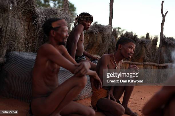 San Bushmen from the Khomani San community gather round a fire in the Southern Kalahari Desert on October 16, 2009 in the Kalahari, South Africa. One...