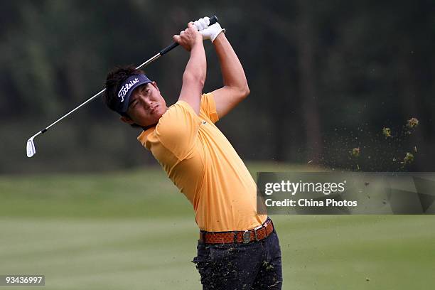 Ryuji Imada of Japan plays a shot on the 14th hole during Fourball on the first day of the Omega Mission Hills World Cup on the Olazabal course on...