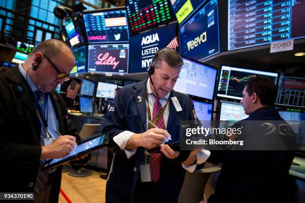 Traders work on the floor of the New York Stock Exchange in New York, U.S., on Monday, March 19, 2018. Stocks declined globally on Monday amid a...