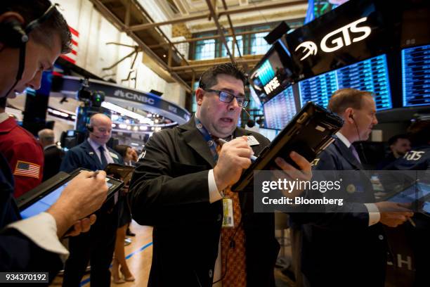 Traders work on the floor of the New York Stock Exchange in New York, U.S., on Monday, March 19, 2018. Stocks declined globally on Monday amid a...