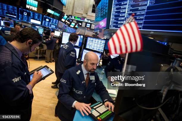 Traders work on the floor of the New York Stock Exchange in New York, U.S., on Monday, March 19, 2018. Stocks declined globally on Monday amid a...