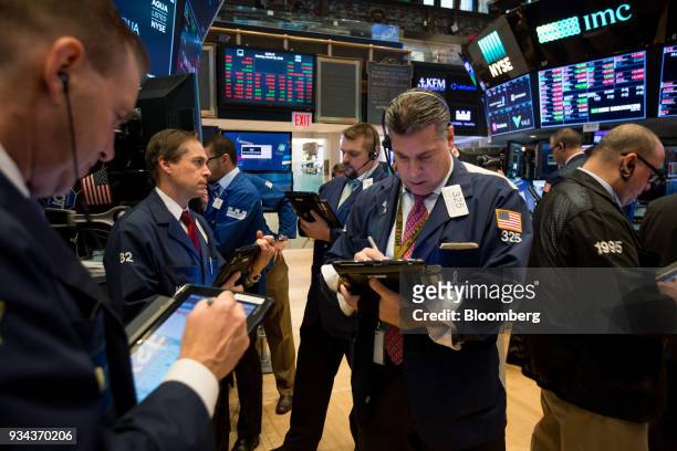 Traders work on the floor of the New York Stock Exchange in New York, U.S., on Monday, March 19, 2018. Stocks declined globally on Monday amid a...