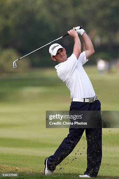 Martin Ureta of Chile plays a shot on the 18th hole during Fourball on the first day of the Omega Mission Hills World Cup on the Olazabal course on...