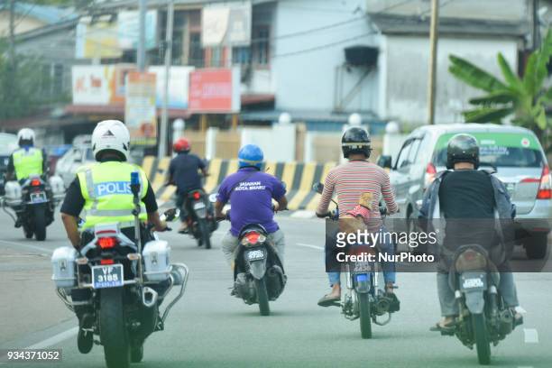 Motorcyclist carries a cat 'Kit' in Kota Bharu city center, near the finish line of the second stage of Le Tour de Langkawi 2018. On Monday, March 19...