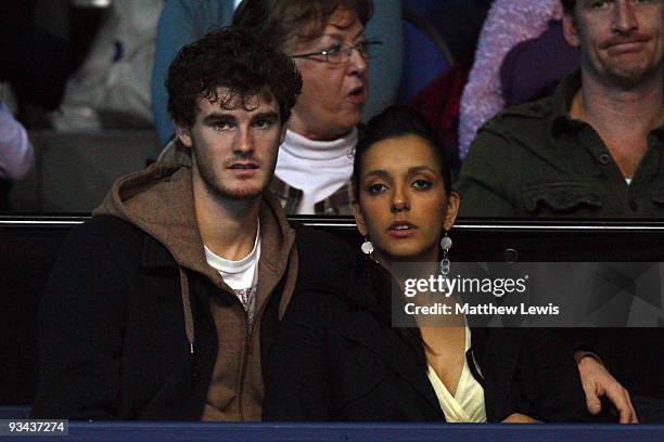 Jamie Murray sits with a friend as he watches his brother Andy Murray of Great Britain play during the men's singles round robin match against...