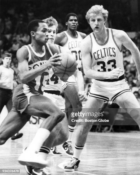 Seattle SuperSonics Gerald Henderson, left, attempts to get by Boston Celtics Larry Bird, right, during a game at the Boston Garden, Jan. 23, 1985....