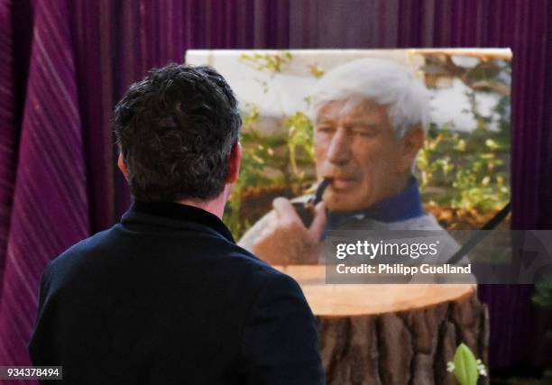 Actor Hans Sigl looks at a memorial portrait the memorial service for Siegfried Rauch at St Ulrich Church on March 19, 2018 in Habach near Murnau,...