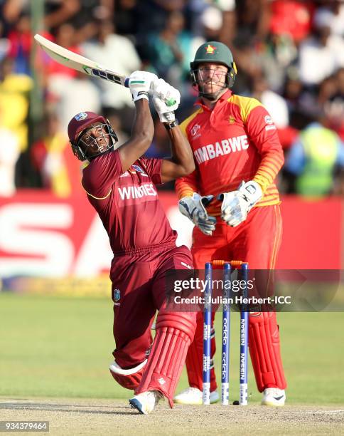 Brendan Taylor of Zimbabwe looks on as Rovman Powell of The West Indies scores runs during The Cricket World Cup Qualifier between The West Indies...