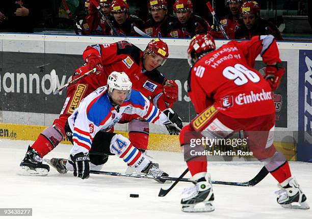 Davod Wolf of Hannover and Tyler Mosienko of Nuernberg battle for the puck during the DEL match between Hannover Scorpions and Thomas Sabo Ice Tigers...
