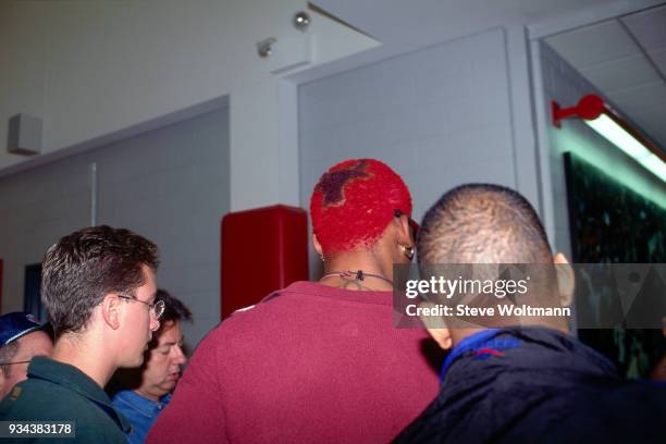 Dennis Rodman walks displaying the Bulls logo in his hair during a press conference to announce he signed with the Chicago Bulls on October 5, 1995...