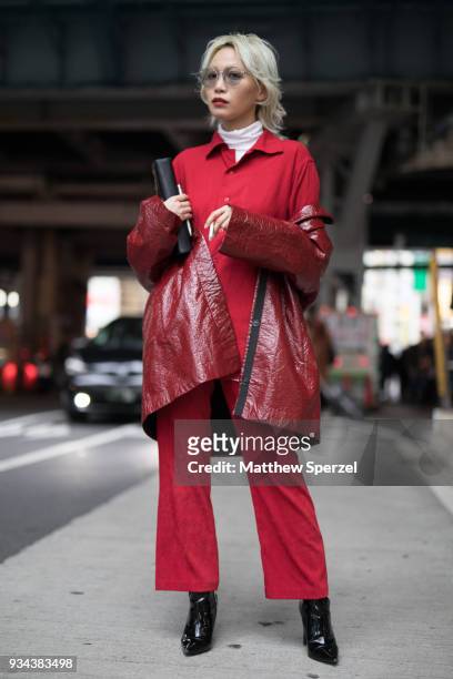 Guest is seen wearing a red jumpsuit with red nylon coat and black shoes during the Amazon Fashion Week TOKYO 2018 A/W on March 19, 2018 in Tokyo,...