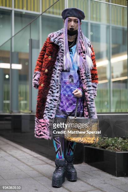Guest is seen wearing a multi-color animal print fur coat and silver platform shoes during the Amazon Fashion Week TOKYO 2018 A/W on March 19, 2018...