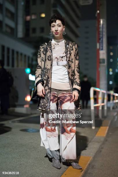 Misha Janette is seen wearing an ornate pattern beige jacket with face design pants and silver shoes during the Amazon Fashion Week TOKYO 2018 A/W on...