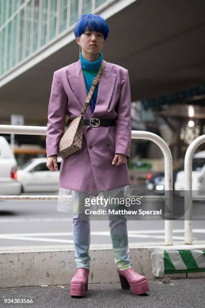 Guest is seen wearing a purple blazer with blue turtleneck sweater, rainbow denim, pink platform shoes during the Amazon Fashion Week TOKYO 2018 A/W...