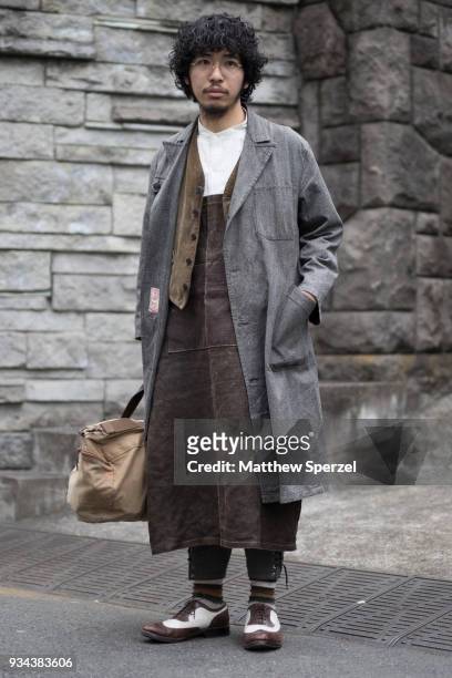Guest is seen wearing a grey coat, olive vest, brown/white leather shoes during the Amazon Fashion Week TOKYO 2018 A/W on March 19, 2018 in Tokyo,...