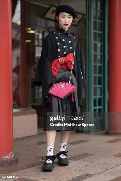 Guest is seen wearing a black/white polka dot top, red bow belt, black skirt, pink bag and black beret during the Amazon Fashion Week TOKYO 2018 A/W...