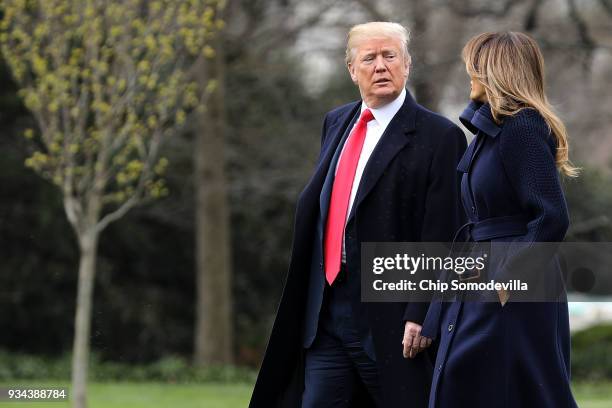 President Donald Trump and first lady Melania Trump walk across the South Lawn as they leave the White House March 19, 2018 in Washington, DC. The...