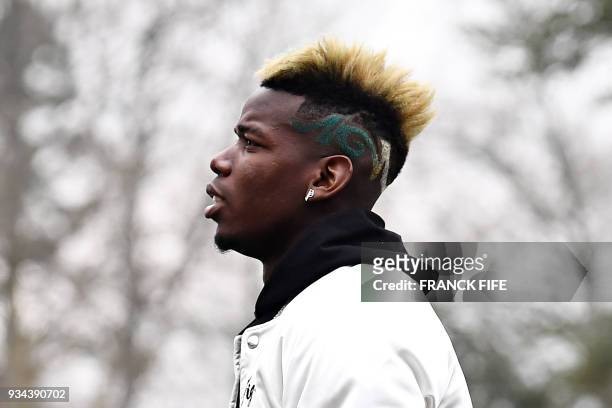 France's midfielder Paul Pogba arrives at the French national football team training base in Clairefontaine-en-Yvelines, on March 19 as part of the...