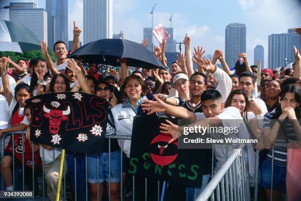 Fans of the Chicago Bulls celebrate at the Bulls 1996 NBA Championship parade on June 18, 1996 in Chicago, Illinois. NOTE TO USER: User expressly...