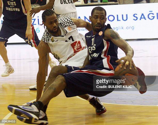 Efes Pilsen's Bootsy Thornton fights for the ball with Orleans' Anthony Dobbins during their Euroleague group match at Ayhan Sahenk sport hall in...