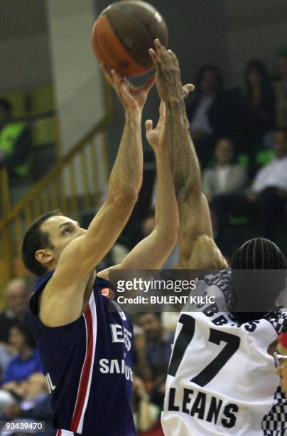 Efes Pilsen's Igor Rakocevic goes for the basket as Orleans' Anthony Dobbins tries to block him during their Euroleague group match at Ayhan Sahenk...