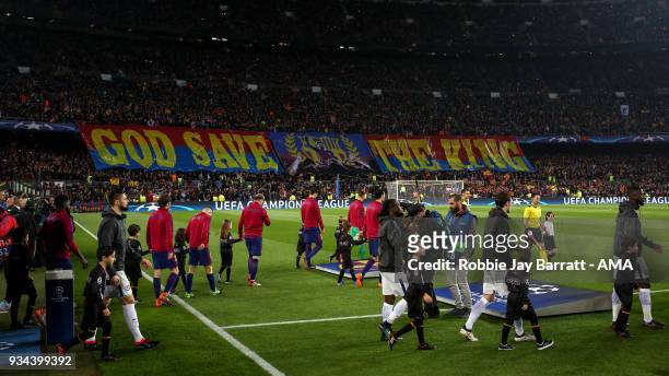 Fans of FC Barcelona hold up a banner for Lionel Messi of FC Barcelona which reads God Save The King as both teams walk out on to the pitch during...
