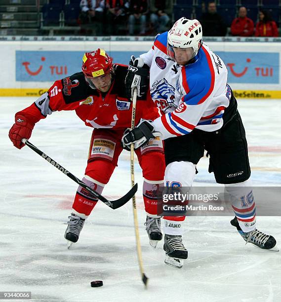 Thomas Dolak of Hannover and Eric Chouinard of Nuernberg battle for the puck during the DEL match between Hannover Scorpions and Thomas Sabo Ice...