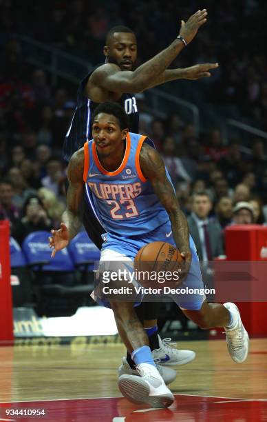 Lou Williams of the Los Angeles Clippers dribbles to the basket past Jonathon Simmons of the Orlando Magic during the NBA game between the Orlando...
