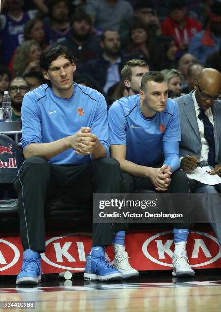 Boban Marjanovic and Sam Dekker of the Los Angeles Clippers look on from the bench area during the NBA game between the Orlando Magic and the Los...