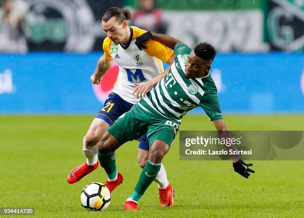 Amadou Moutari of Ferencvarosi TC competes for the ball with Denis Klinar of Puskas Akademia FC during the Hungarian OTP Bank Liga match between...