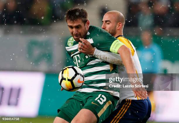 Daniel Bode of Ferencvarosi TC covers the ball from Jonathan Heris of Puskas Akademia FC during the Hungarian OTP Bank Liga match between...