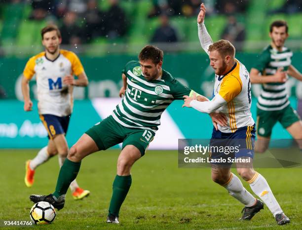 Daniel Bode of Ferencvarosi TC competes for the ball with Janos Hegedus of Puskas Akademia FC during the Hungarian OTP Bank Liga match between...