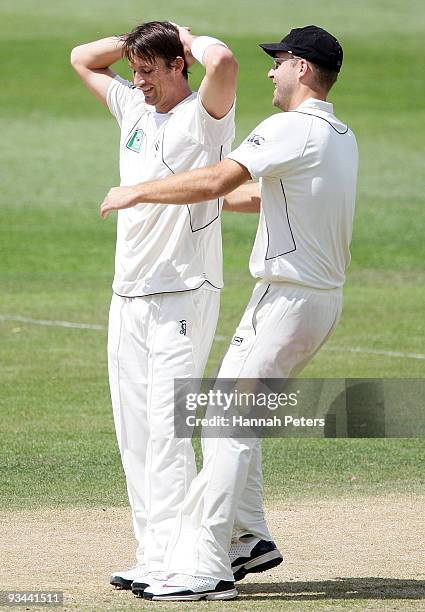 Shane Bond is congratulated by Daniel Vettori after taking a five wicket haul during day four of the First Test match between New Zealand and...