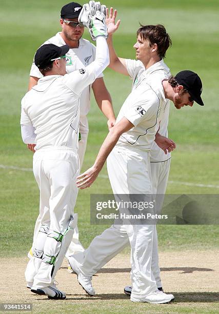 Shane Bond of New Zealand celebrates taking a five wicket haul during day four of the First Test match between New Zealand and Pakistan at University...