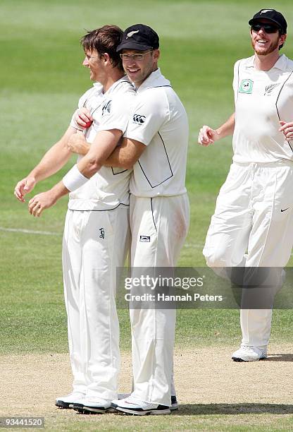 Shane Bond is congratulated by Daniel Vettori after taking a five wicket haul during day four of the First Test match between New Zealand and...