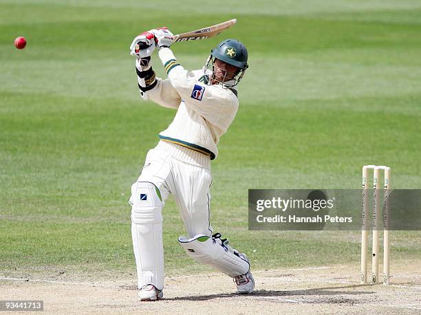 Mohammad Aamer of Pakistan drives the ball away for four runs during day four of the First Test match between New Zealand and Pakistan at University...