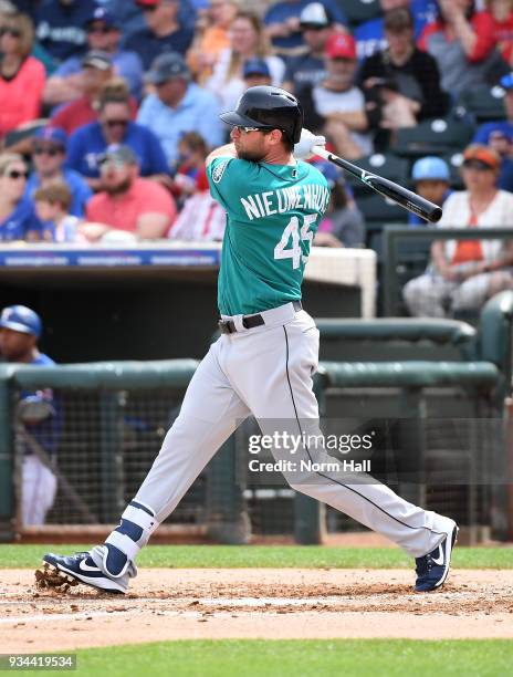 Kirk Nieuwenhuis of the Seattle Mariners follows through on a swing against the Texas Rangers during a spring training game at Surprise Stadium on...