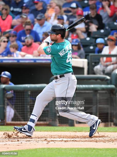 Kirk Nieuwenhuis of the Seattle Mariners follows through on a swing against the Texas Rangers during a spring training game at Surprise Stadium on...