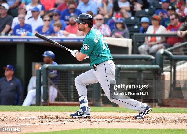 Kirk Nieuwenhuis of the Seattle Mariners follows through on a swing against the Texas Rangers during a spring training game at Surprise Stadium on...