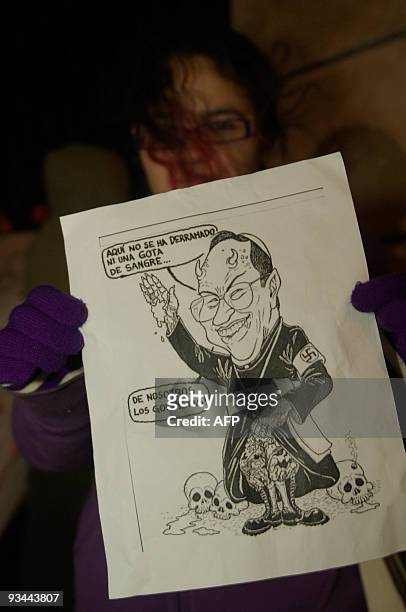 Guatemalan woman with the Resistance Front displays a caricature of Honduran Cardinal Oscar Rodriguez, who they blame for supporting the coup in...