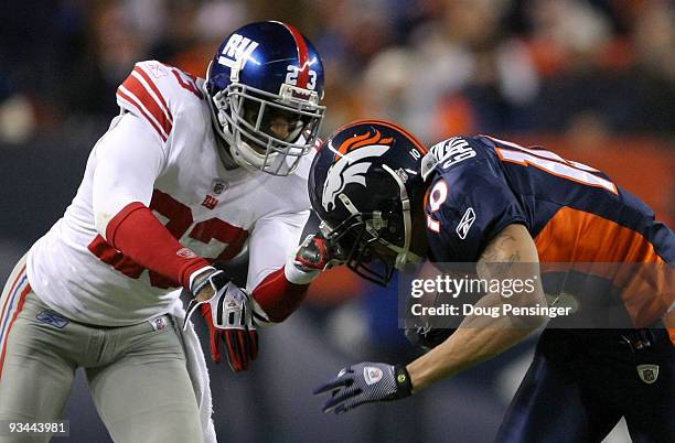 Wide receiver Jabar Gaffney of the Denver Broncos makes an eight yard pass reception as Corey Webster of the New York Giants is penalized 15 yards...