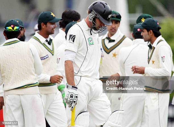 Tim McIntosh of New Zealand walks off after being dismissed lbw by Mohammad Asif during day four of the First Test match between New Zealand and...