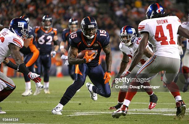 Wide receiver Brandon Marshall of the Denver Broncos makes a pass reception before being corralled by Aaron Rouse, Terrell Thomas and C.C. Brown of...